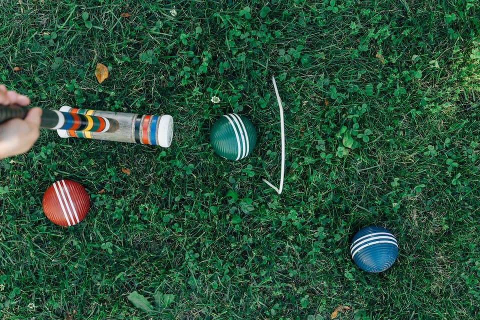 A croquet mallet, balls and hoop - Photo by Erol Ahmed on Unsplash