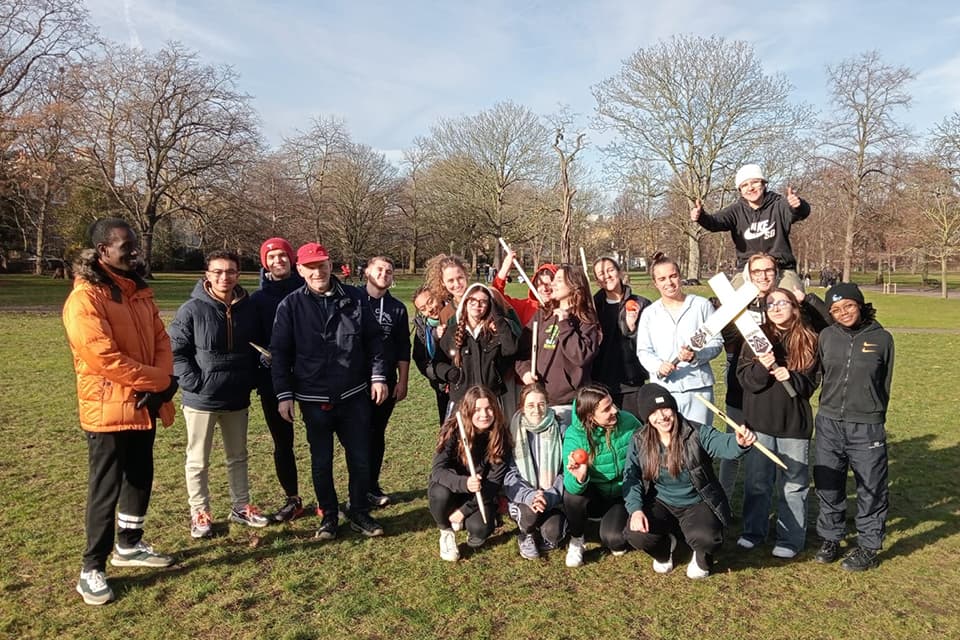 A group of students gathered to play cricket